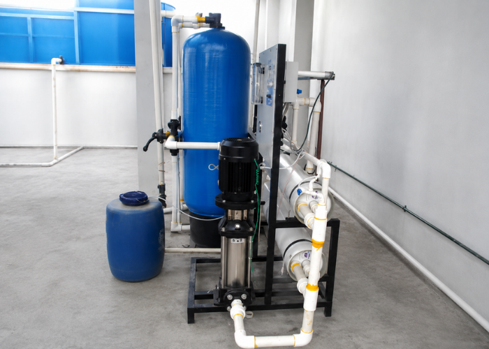 Technician servicing industrial water treatment equipment